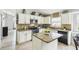 Bright kitchen featuring granite countertops, tile backsplash, white cabinetry and an island at 7243 Minippi Dr, Orlando, FL 32818