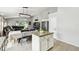 Bright kitchen with granite countertops and island, dining space, and entry to the living area at 7243 Minippi Dr, Orlando, FL 32818