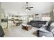 Open floorplan of the kitchen, dining and living room featuring tile flooring and modern furnishings at 7243 Minippi Dr, Orlando, FL 32818
