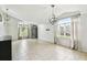 Bright living room featuring tile flooring, vaulted ceilings, and large windows at 7243 Minippi Dr, Orlando, FL 32818