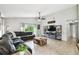 Open-concept living room and kitchen featuring tile flooring, ample natural light, and comfortable furnishings at 7243 Minippi Dr, Orlando, FL 32818