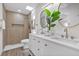 Modern bathroom features a dual vanity, a stylish skylight, and a beautiful walk-in shower at 822 Glen Arden Way, Altamonte Springs, FL 32701