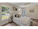 Bright bedroom featuring a plush bed, modern ceiling fan, and natural light from a large window at 822 Glen Arden Way, Altamonte Springs, FL 32701