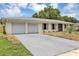 Single story home featuring an attached two car garage and front yard with a concrete driveway at 822 Glen Arden Way, Altamonte Springs, FL 32701