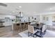 Open kitchen and dining area featuring stainless steel appliances, an island with seating, and a modern aesthetic at 822 Glen Arden Way, Altamonte Springs, FL 32701