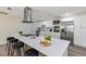 Kitchen featuring white cabinetry, stainless steel appliances, a quartz countertop island with seating, and sleek range hood at 822 Glen Arden Way, Altamonte Springs, FL 32701