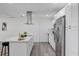 Bright kitchen with island, stainless appliances, white cabinets and quartz countertops at 822 Glen Arden Way, Altamonte Springs, FL 32701