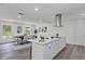 Bright open kitchen with island, stainless appliances, a modern range hood, and lots of cabinets at 822 Glen Arden Way, Altamonte Springs, FL 32701
