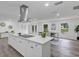 Bright open kitchen with island, stainless appliances, a modern range hood, and lots of cabinets at 822 Glen Arden Way, Altamonte Springs, FL 32701