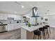 Bright kitchen with stainless steel appliances, white cabinets, a large island with bar stools, and ample counter space at 822 Glen Arden Way, Altamonte Springs, FL 32701