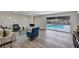 Living room with views of the outdoor pool area, complemented by stylish furniture and a fireplace at 822 Glen Arden Way, Altamonte Springs, FL 32701