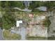 Aerial view of the property and surrounding area showcases the home and adjacent lot and outbuildings at 8812 Oakwood Dr, Lake Wales, FL 33898