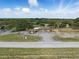 Aerial view of a home and property from above the road, showcasing its layout and landscaping at 8812 Oakwood Dr, Lake Wales, FL 33898