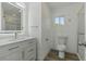 Well-lit bathroom with updated vanity, modern fixtures, walk-in shower and hardwood floors at 8812 Oakwood Dr, Lake Wales, FL 33898