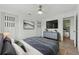 Bedroom featuring a large bed, mounted TV, and sliding closet doors at 8812 Oakwood Dr, Lake Wales, FL 33898