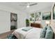 Bedroom featuring a bed with teal pillows, a closet, and a bright window at 8812 Oakwood Dr, Lake Wales, FL 33898