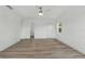 Spacious bedroom with hardwood floors, ceiling fan, and three doors, including one to the bathroom at 8812 Oakwood Dr, Lake Wales, FL 33898