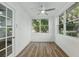 Bright bedroom featuring hardwood floors, a ceiling fan and natural light from the windows at 8812 Oakwood Dr, Lake Wales, FL 33898