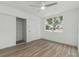 Bedroom with hardwood floors, window, closet and door at 8812 Oakwood Dr, Lake Wales, FL 33898