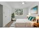 Bright bedroom featuring a large window and a bed with comfortable pillows at 8812 Oakwood Dr, Lake Wales, FL 33898