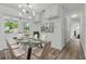 Dining area with a glass table, six chairs, and modern lighting at 8812 Oakwood Dr, Lake Wales, FL 33898