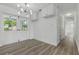 Bright dining room with wood floors and modern lighting at 8812 Oakwood Dr, Lake Wales, FL 33898