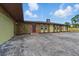 Home exterior showcases a stone facade, brown trim, and a concrete driveway in front of the property at 8812 Oakwood Dr, Lake Wales, FL 33898