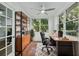 Home office with natural light, a desk, ceiling fan, and storage space at 8812 Oakwood Dr, Lake Wales, FL 33898