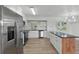 Bright kitchen features stainless appliances, white cabinets, and a center island with a dark countertop at 8812 Oakwood Dr, Lake Wales, FL 33898
