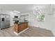 Eat-in kitchen with stainless steel appliances, island and glass doors at 8812 Oakwood Dr, Lake Wales, FL 33898