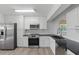 Well-lit kitchen features stainless appliances, black countertops, and ample cabinet space at 8812 Oakwood Dr, Lake Wales, FL 33898