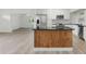 Modern kitchen with an island, stainless steel appliances, and bright white cabinets at 8812 Oakwood Dr, Lake Wales, FL 33898
