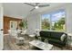 Airy living room featuring large windows, comfortable seating, and bright decor at 8812 Oakwood Dr, Lake Wales, FL 33898