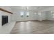 Bright living room featuring wood flooring, white walls, fireplace, and natural light at 8812 Oakwood Dr, Lake Wales, FL 33898