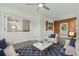 Cozy living room featuring wood paneling, textured walls, and comfortable seating at 8812 Oakwood Dr, Lake Wales, FL 33898