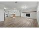 Open-concept living space with a kitchen island, modern lighting, and a fireplace at 8812 Oakwood Dr, Lake Wales, FL 33898