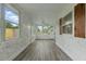 Bright enclosed sunroom featuring wood shutters and multiple windows at 8812 Oakwood Dr, Lake Wales, FL 33898