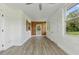 Enclosed sunroom featuring wood accents, textured walls, and multiple doors at 8812 Oakwood Dr, Lake Wales, FL 33898