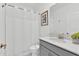 Neat bathroom with shower-tub combination, and a single vanity with a gray cabinet at 9239 Sommerset Hills Dr, Davenport, FL 33896