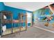 Themed bedroom with bunk beds and a vibrant mural creates a fun, playful atmosphere at 9239 Sommerset Hills Dr, Davenport, FL 33896