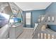 A bedroom featuring bunk beds, a gray dresser with TV, and a cool space mural at 9239 Sommerset Hills Dr, Davenport, FL 33896