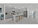 Bright kitchen featuring gray cabinets, stainless steel appliances, a center island and modern countertops at 9239 Sommerset Hills Dr, Davenport, FL 33896