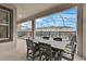 Covered patio with dining table overlooking a screened pool and backyard at 9239 Sommerset Hills Dr, Davenport, FL 33896