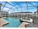 Beautiful screened pool and spa with backyard and lounge chairs at 9239 Sommerset Hills Dr, Davenport, FL 33896