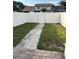 Backyard featuring a new white fence and stone pavers, ideal for relaxation and privacy at 9471 Comeau St, Gotha, FL 34734