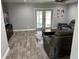 Open-concept living room featuring a ceiling fan, hardwood floors, and glass patio doors to the outdoors at 9471 Comeau St, Gotha, FL 34734