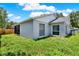 Well-maintained backyard showing the home's exterior, windows, and manicured lawn at 963 Beach Breeze Dr, Orlando, FL 32835