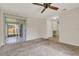 Bedroom featuring neutral carpet, ceiling fan, and a glass sliding door to the patio at 963 Beach Breeze Dr, Orlando, FL 32835