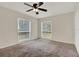 Spacious carpeted bedroom with ceiling fan and large windows for ample natural light at 963 Beach Breeze Dr, Orlando, FL 32835
