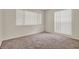 Neutral bedroom featuring plush carpeting and bright windows, offering a serene atmosphere at 963 Beach Breeze Dr, Orlando, FL 32835